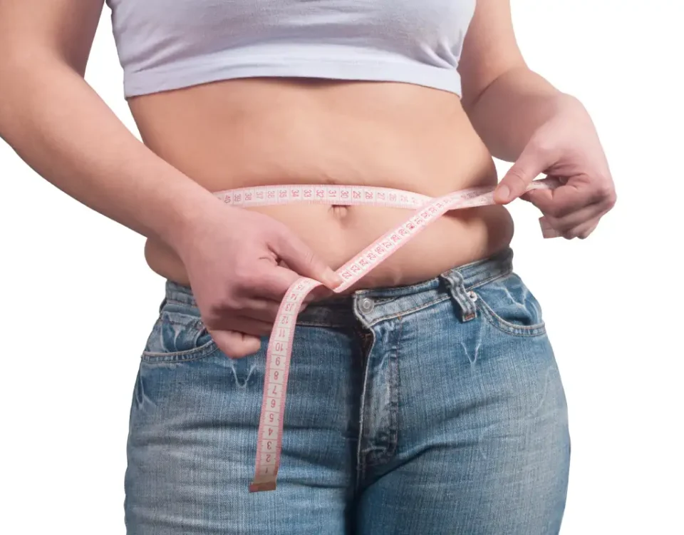 A woman measuring their waist get treat weight loss treatment in Salem, NH at JSJ Aesthetics