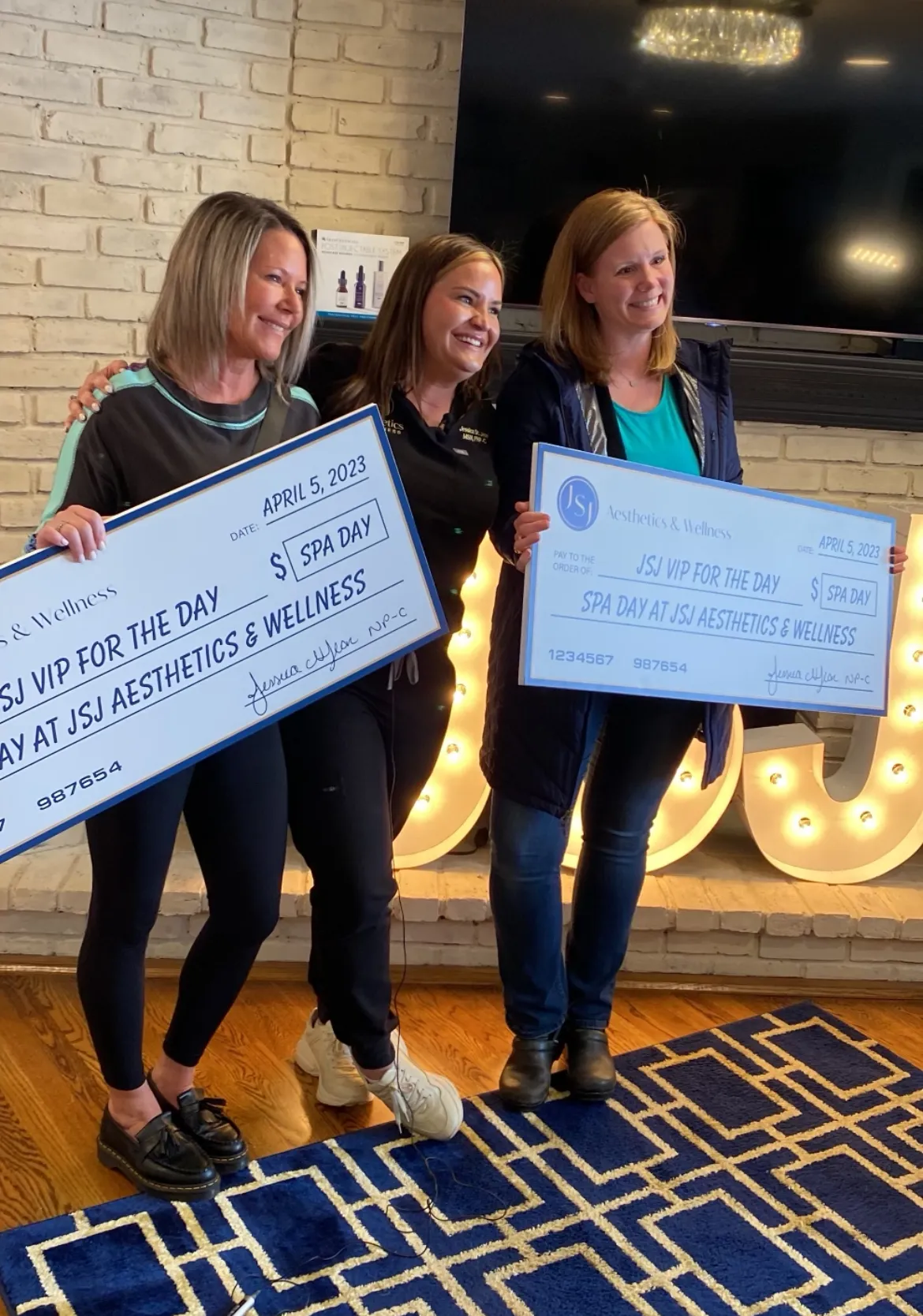 a group of women holding a check