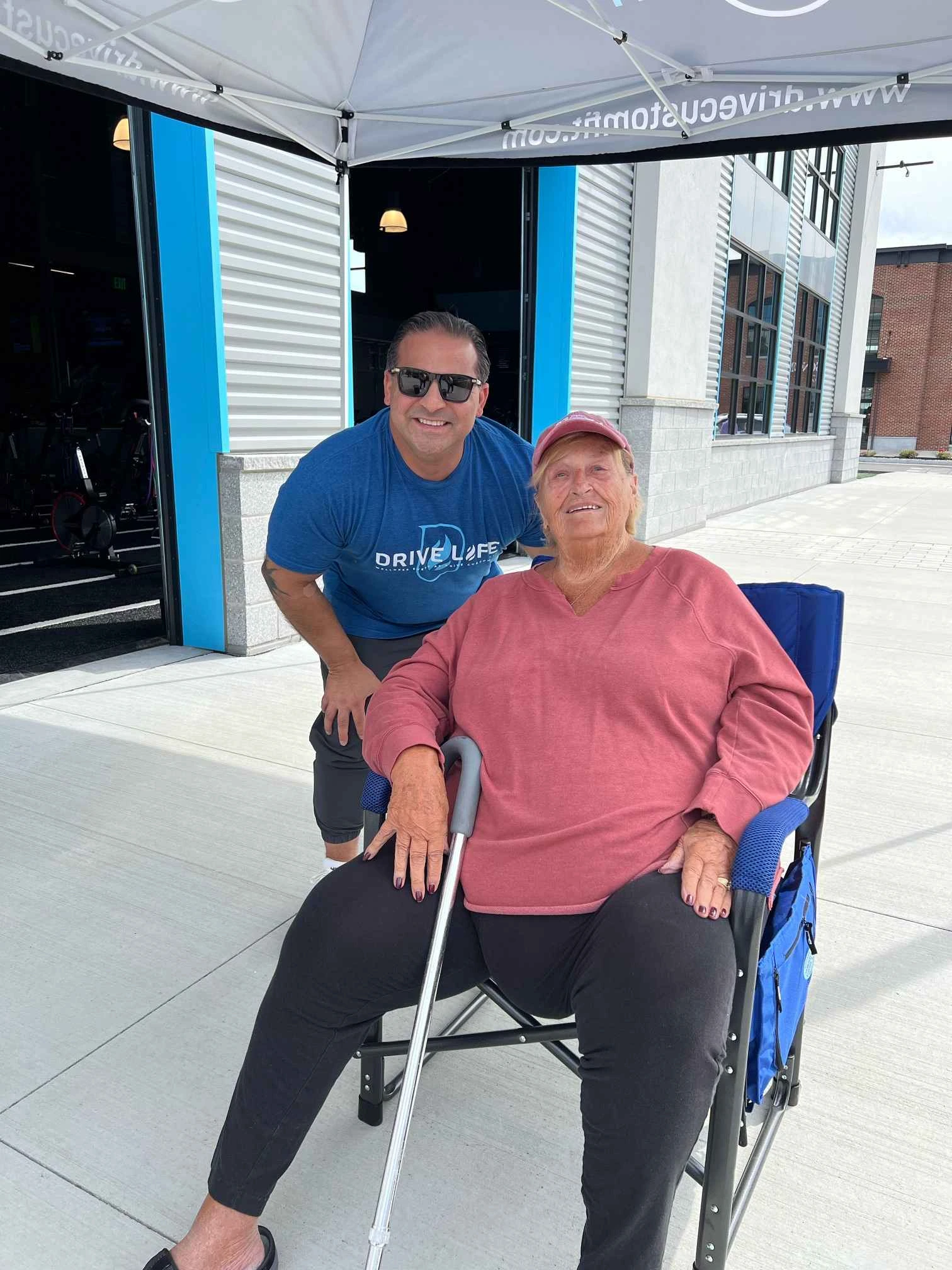 a man and woman sitting in a wheelchair