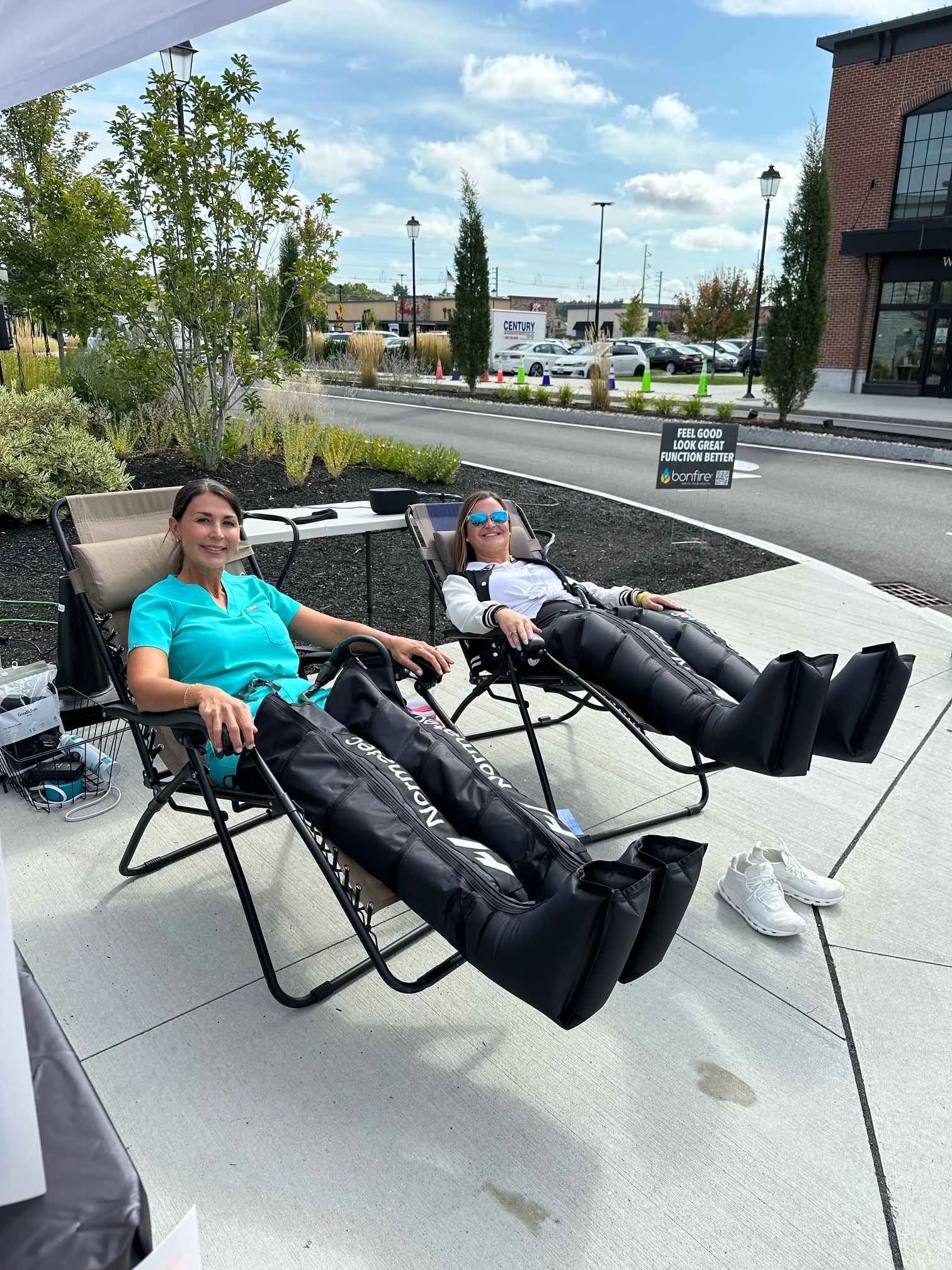 a couple of women sitting in chairs outside