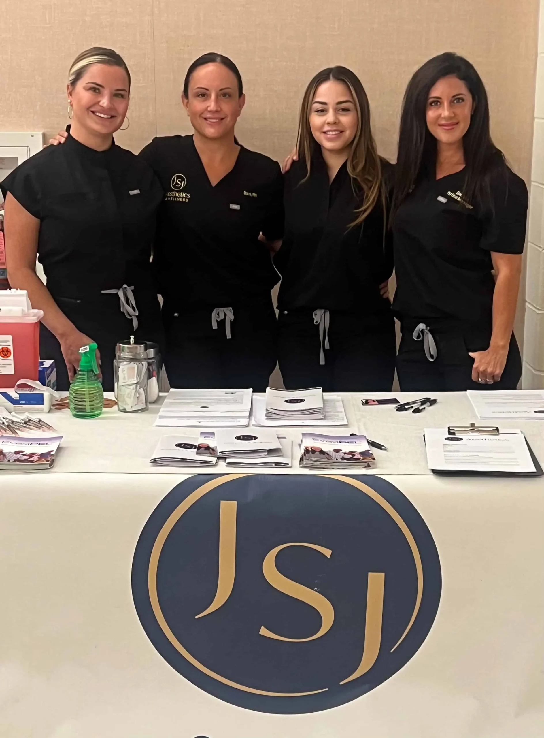 a group of women standing in front of a table