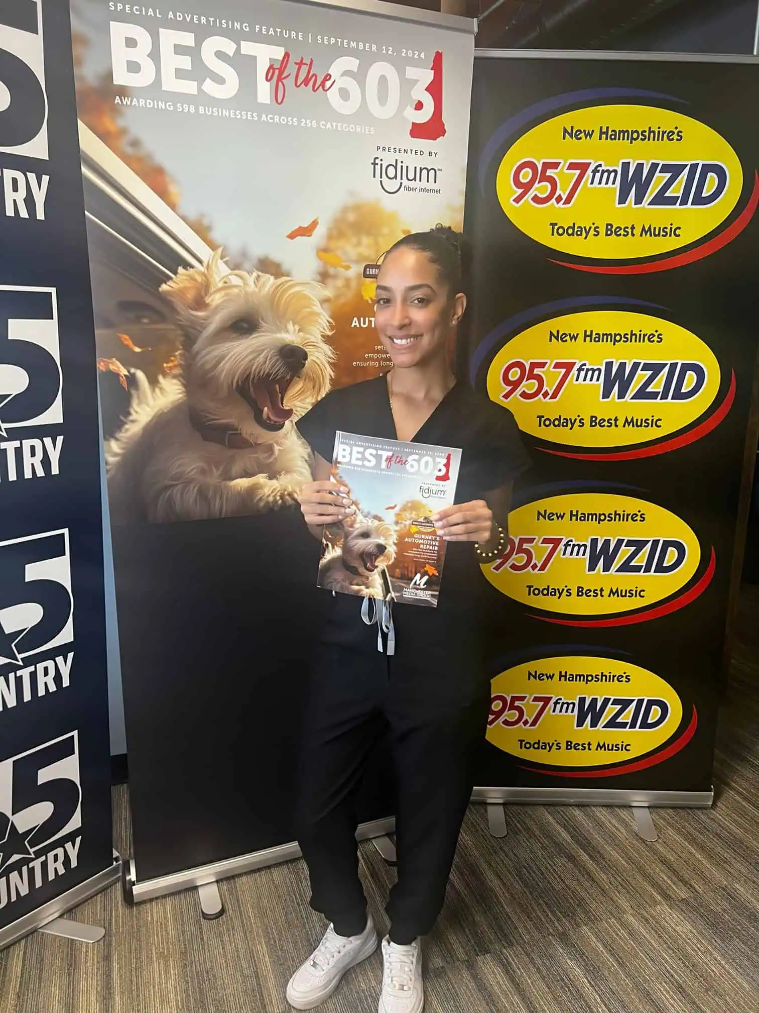 a woman standing in front of a poster