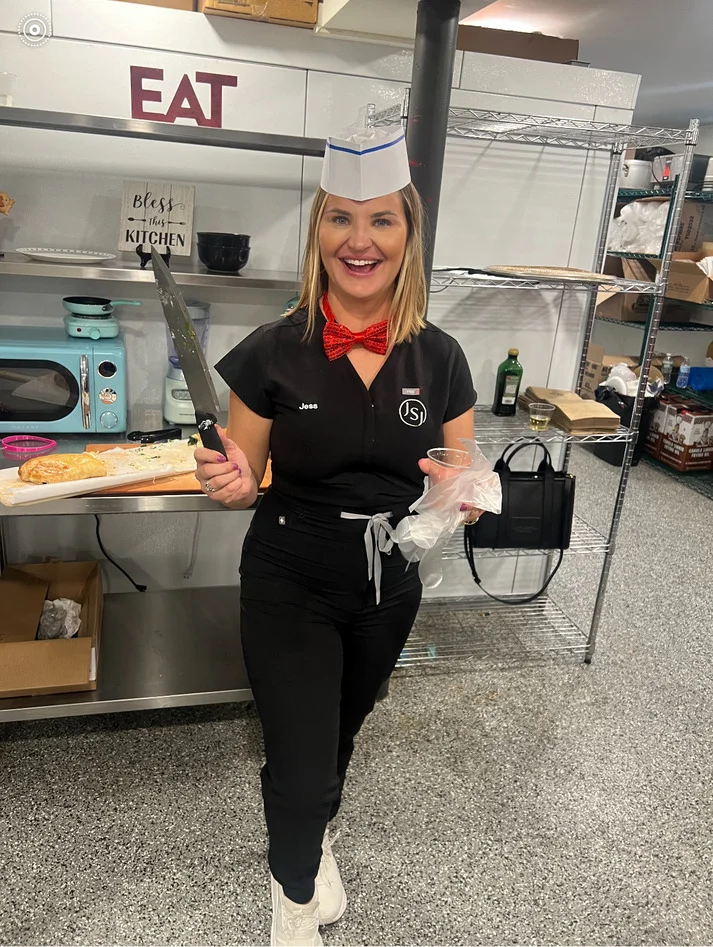 a woman in a uniform holding a knife