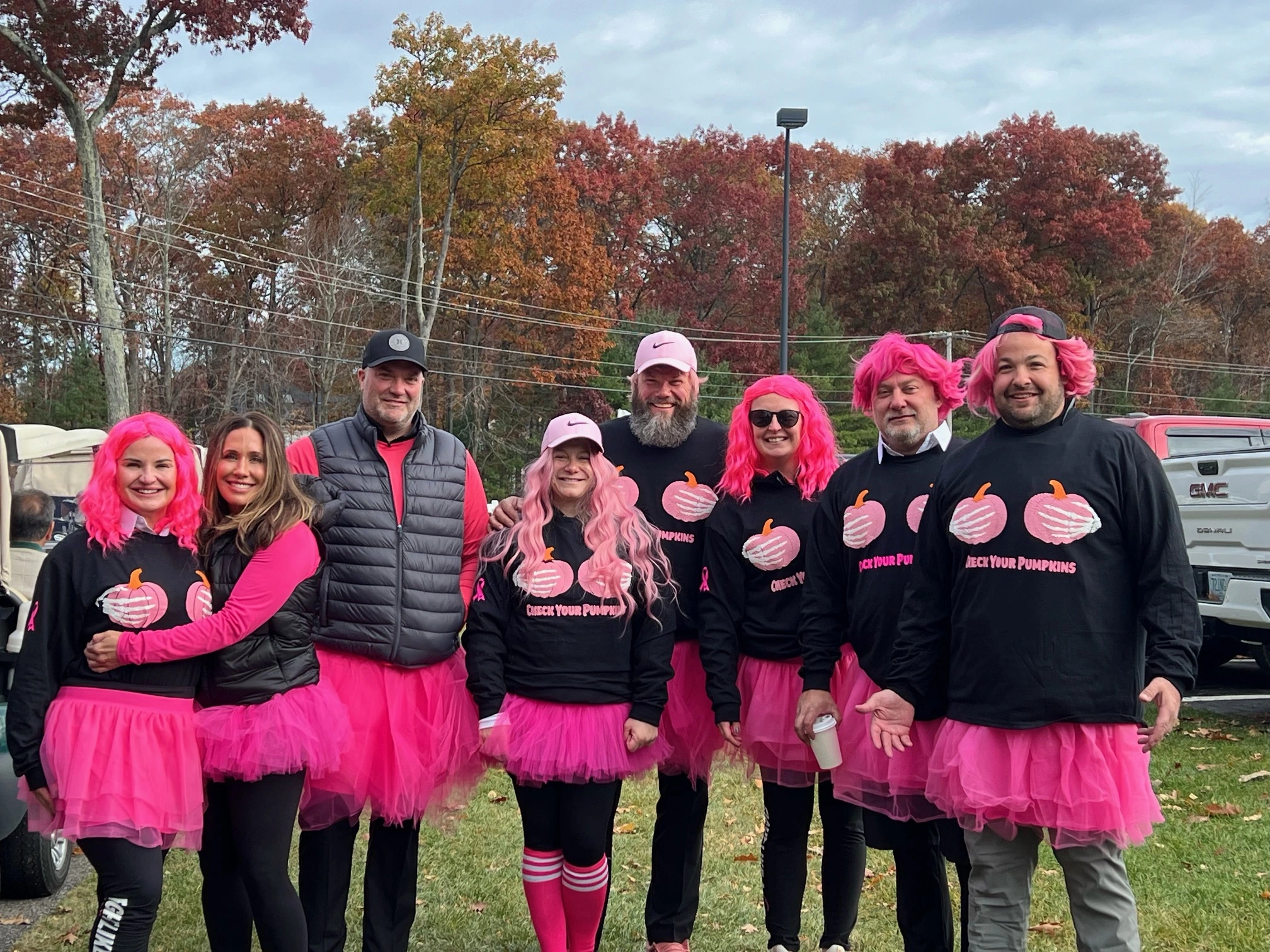 a group of people wearing pink and black matching outfits