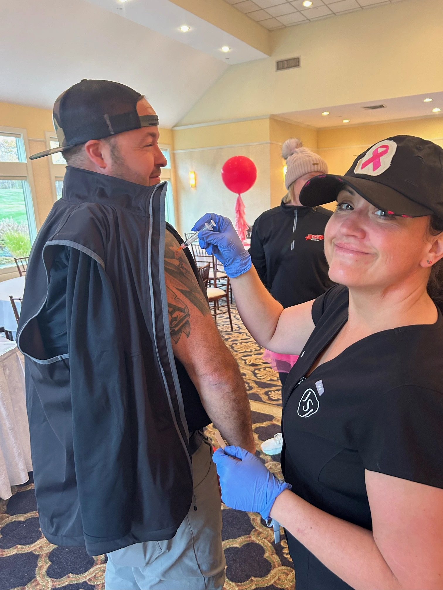 a woman giving a man a tattoo