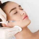 Woman receiving a Botox injection treatment in Salem, NH in her cheek from a medical professional