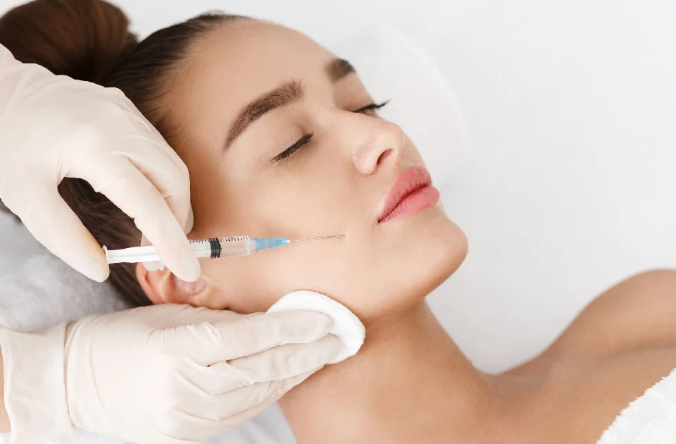 Woman receiving a Botox injection treatment in Salem, NH in her cheek from a medical professional