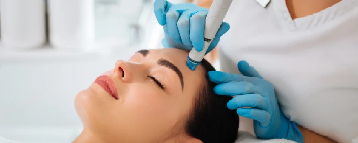 A woman receiving a HydraFacial treatment in Salem, NH