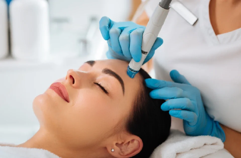 A woman receiving a HydraFacial treatment in Salem, NH