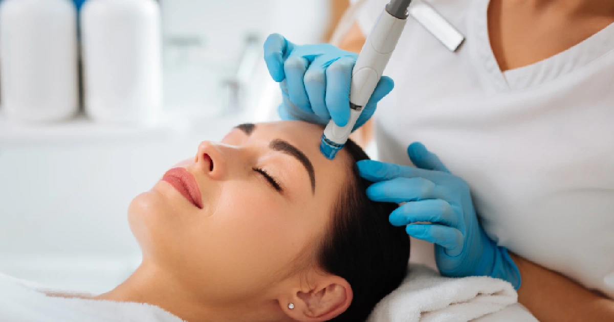 A woman receiving a HydraFacial treatment in Salem, NH