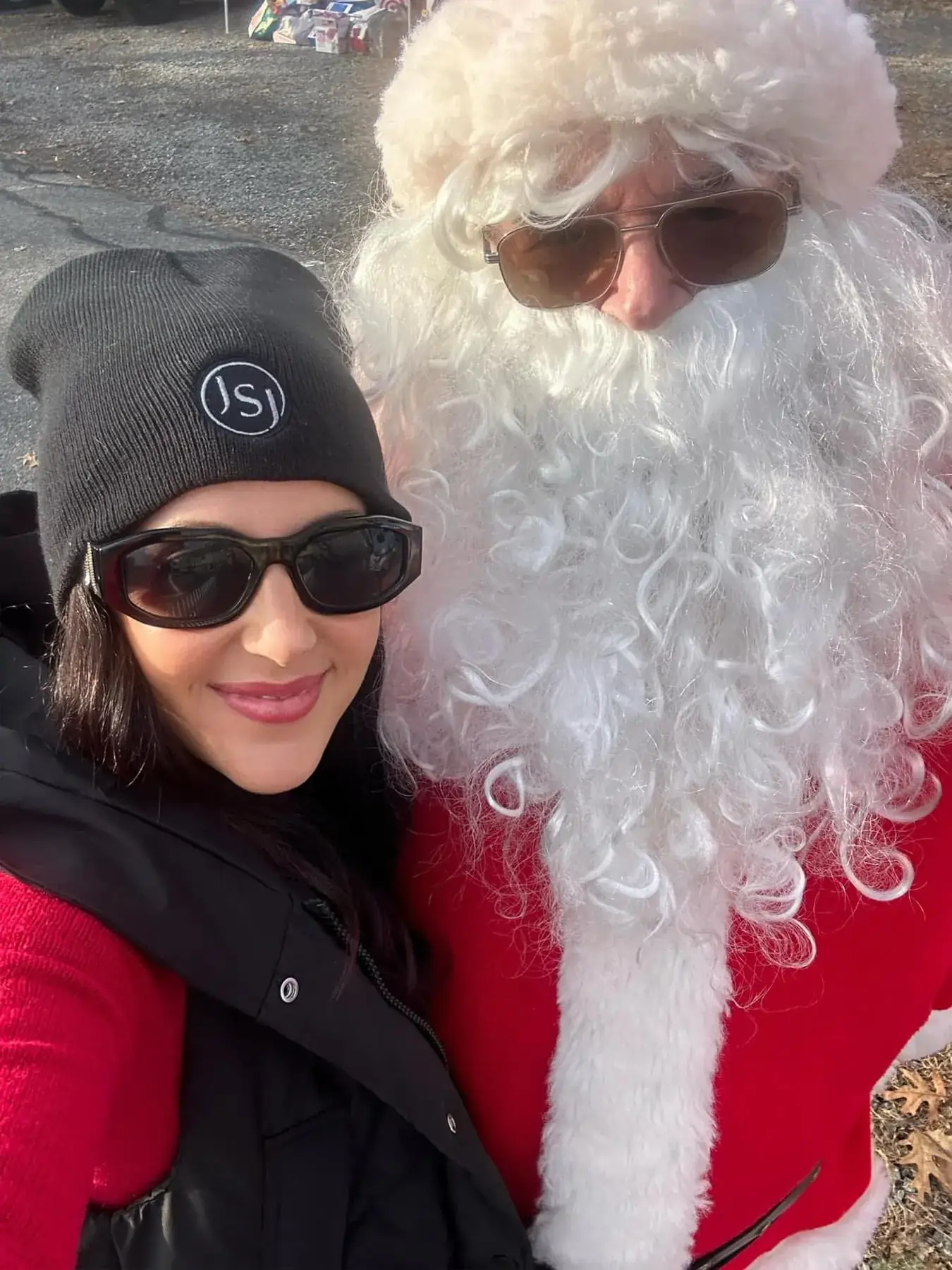 a woman taking a selfie with a man in a garment