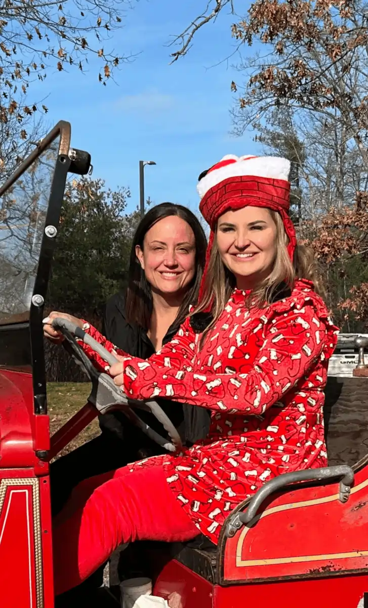 two women in red and white outfits in a car