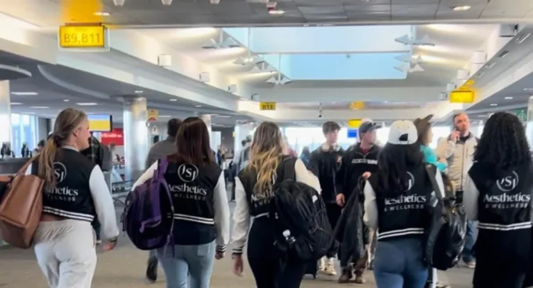 a group of people walking in an airport